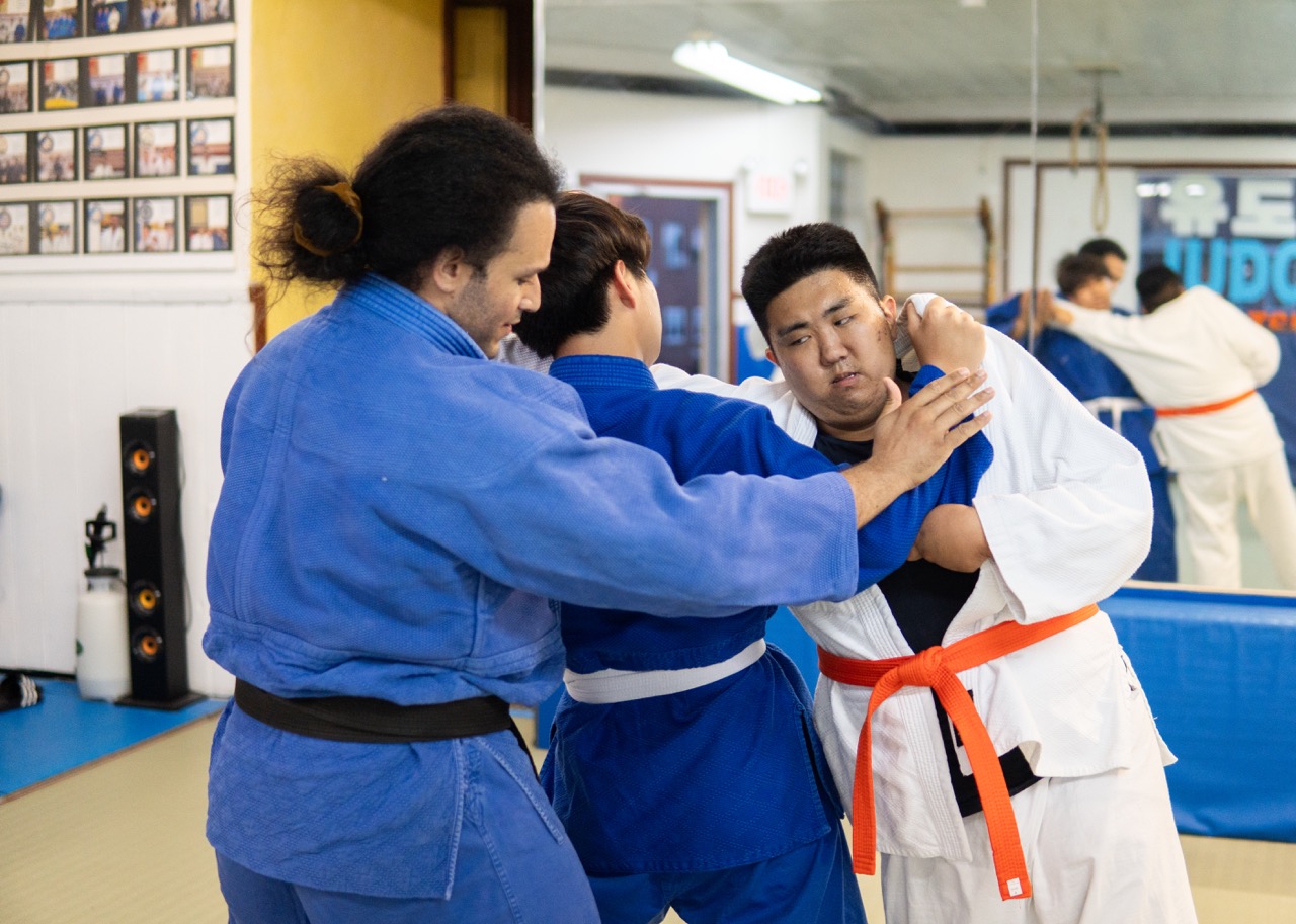 Instructor teaching judo techniques